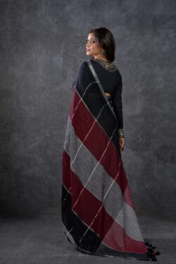 Model wearing Playful Pure Cotton Linen Saree in Black, Maroon, and Grey Check Pattern – Back View