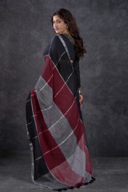 Model wearing Playful Pure Cotton Linen Saree in Black, Maroon, and Grey Check Pattern – Back View